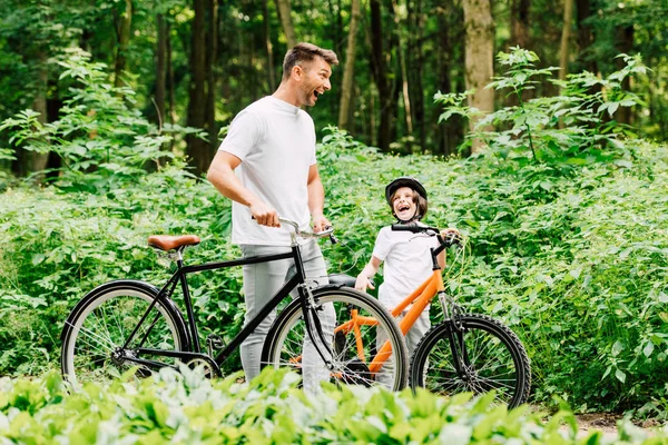 Selective Focus Father Son Laughing While Standing Bicycles Road Forest — Stock Photo, Image