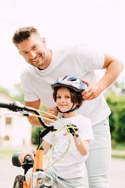 Selective Focus Father Son Looking Camera While Dad Putting Helmet — Stock Photo, Image