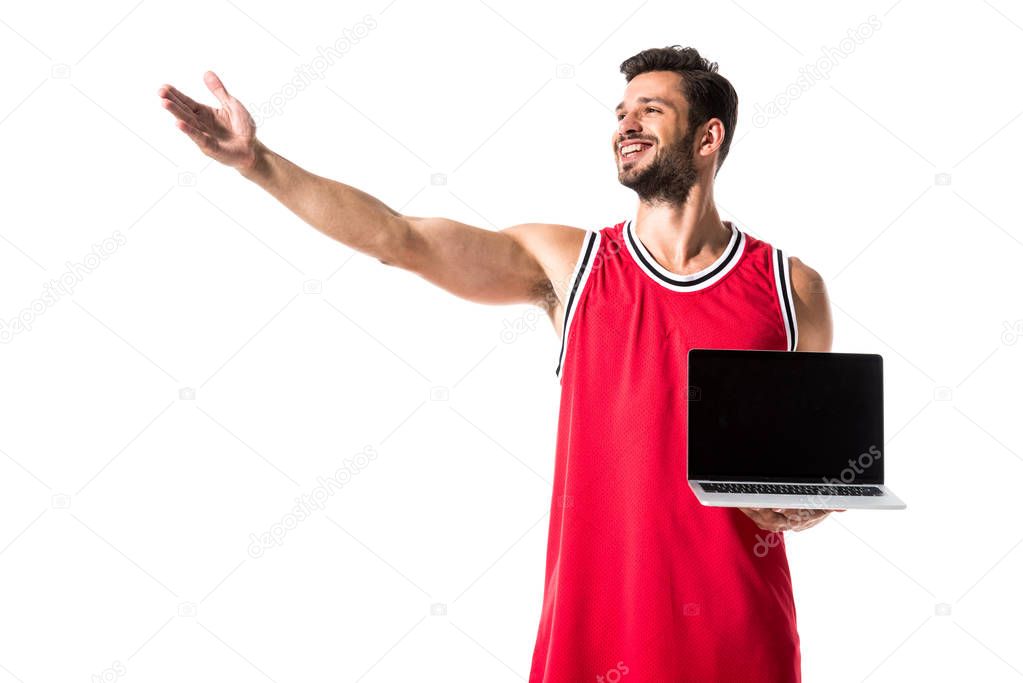 basketball player in uniform with laptop and outstretched hand Isolated On White 