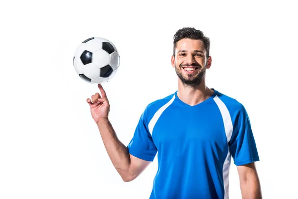Χαμογελαστός Όμορφος Ποδοσφαιριστής Γυρίζοντας Στο Δάχτυλο Μπάλα Απομονωμένος Λευκό — Φωτογραφία Αρχείου