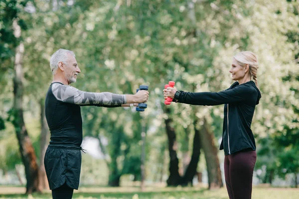 Side View Smiling Mature Sportsman Sportswoman Training Barbells Park Looking — Stock Photo, Image