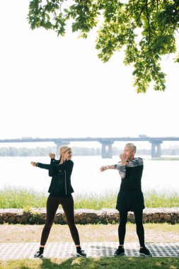 olgun sporcu ve sporcu ısınma ve parkta birbirlerine bakıyor