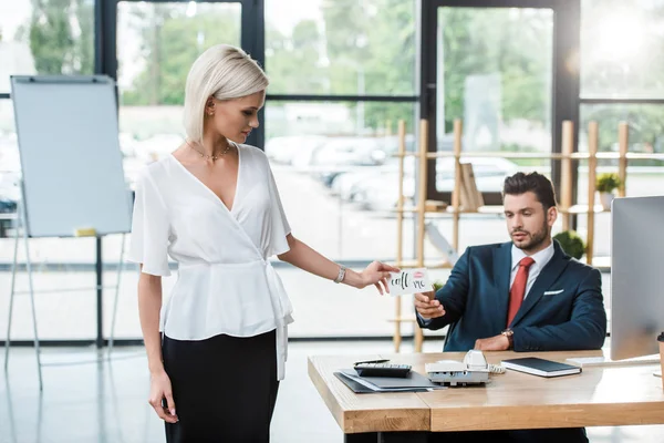 Attractive Blonde Girl Giving Card Call Lettering Man Office — Stock Photo, Image