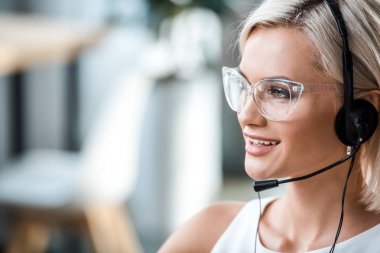 close up of beautiful blonde operator in glasses and headset  clipart