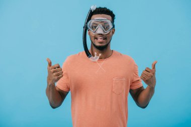 happy african american man in diving mask showing thumbs up isolated on blue  clipart