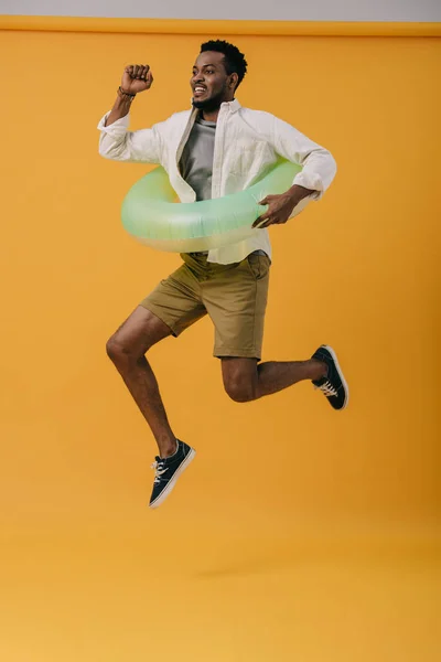 Cheerful Bearded African American Man Jumping Swim Ring Orange — Stock Photo, Image