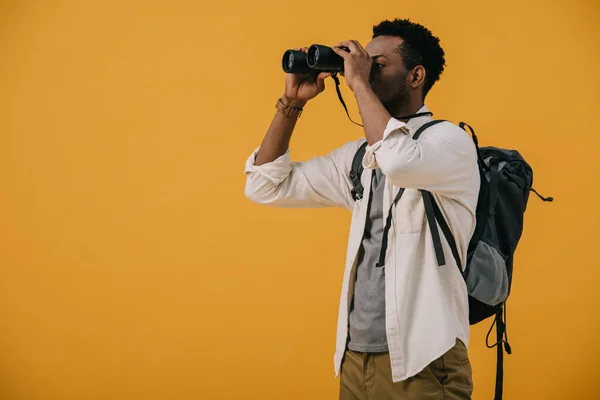 Αφρικανός Αμερικανός Άνθρωπος Κοιτάζοντας Μέσα Από Κιάλια Απομονώνονται Πορτοκαλί — Φωτογραφία Αρχείου