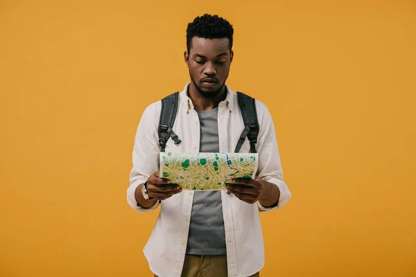 Bonito Afro Americano Homem Com Mochila Olhando Mapa Isolado Laranja — Fotografia de Stock