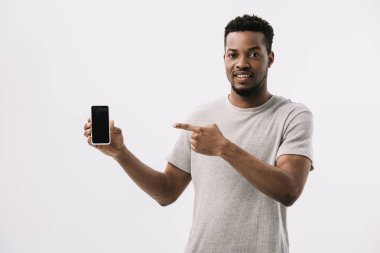 beyaz izole boş ekran ile akıllı telefon parmak ile işaret mutlu afrikalı amerikalı adam 
