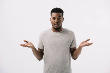 confused african american man showing shrug gesture isolated on grey  clipart