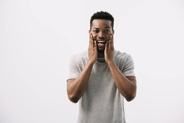 scared african american man touching face isolated on white 