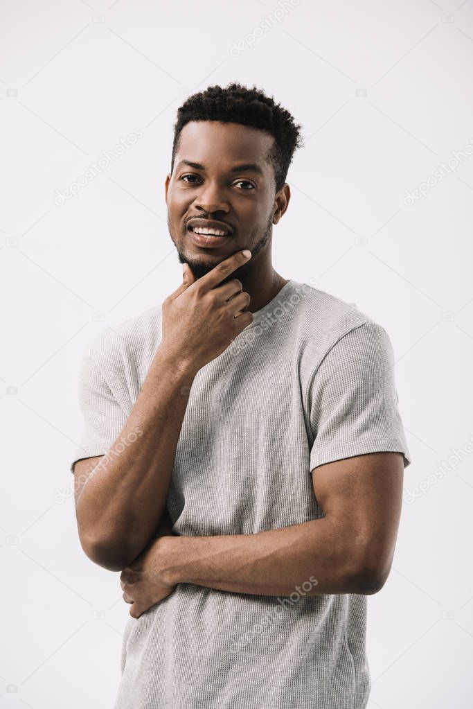 happy african american man touching face isolated on white 