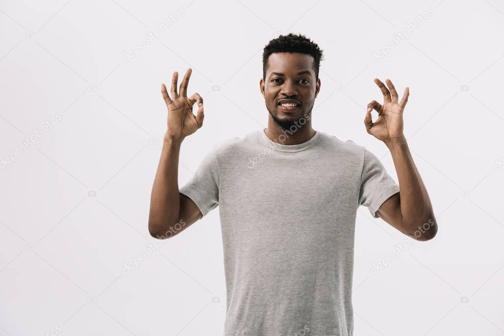happy african american man showing ok sign isolated on white