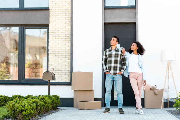 full length view of african american wife leaning on man while looking away