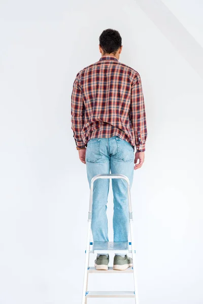 Back View Man Standing Ladder Looking Wall Isolated White — Stock Photo, Image