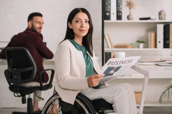 Selective Positive Disabled Businesswoman Holding Newspaper Looking Camera While Sitting — Stock Photo, Image