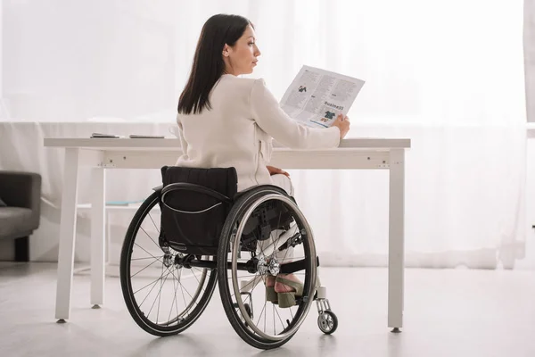 Young Disabled Businesswoman Holding Newspaper While Sitting Wheelchair Workplace — Stock Photo, Image