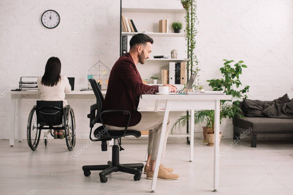 handsome businessman and disabled businesswoman working in office 