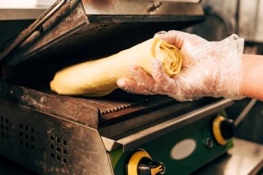 partial view of cook in glove preparing doner kebab clipart