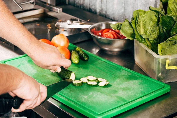 厨师在切板上切黄瓜的裁剪视图 — 图库照片