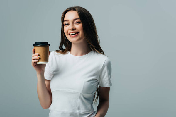 happy beautiful girl in white t-shirt with paper cup isolated on grey