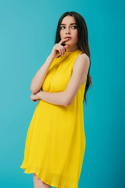 Thoughtful Beautiful Girl Yellow Dress Looking Away Isolated Turquoise — Stock Photo, Image