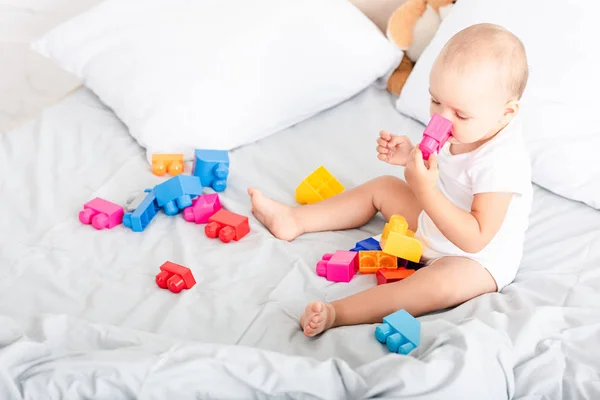 Barefoot Baby White Clothes Sitting Bed Toys Taking Piece Construction — Stock Photo, Image