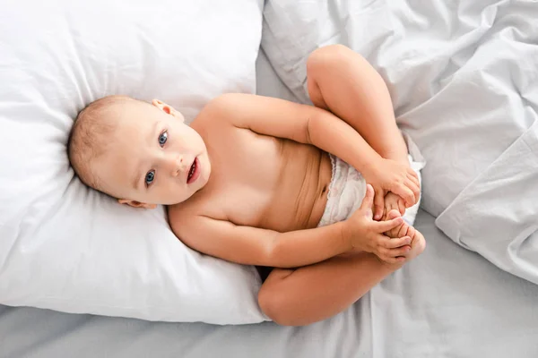 Top View Little Baby Diaper Laying Back Grabbing Feet Hands — Stock Photo, Image