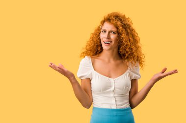 confused redhead woman with shrug gesture, isolated on yellow clipart