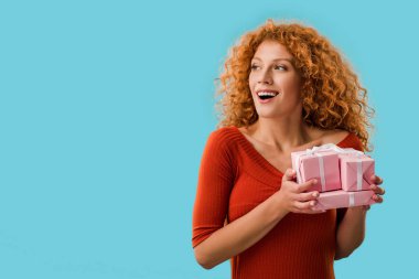 happy woman holding gifts isolated on blue clipart