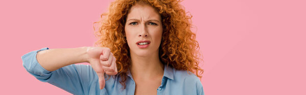 redhead woman showing thumb down Isolated On pink   