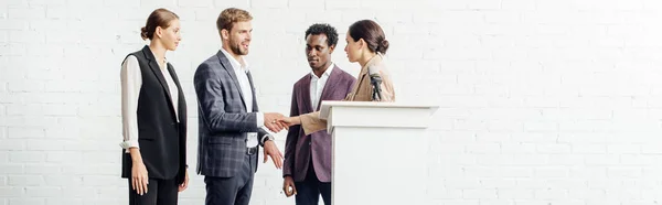 Panoramic Shot Four Multiethnic Colleagues Formal Wear Talking Shaking Hands — Stock Photo, Image