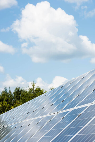 cloudy sky and blue solar energy batteries with copy space 