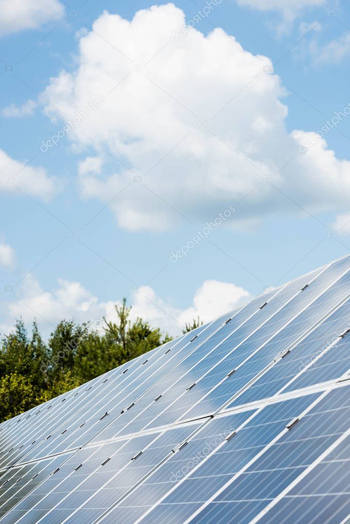 cloudy sky and blue solar energy batteries with copy space 