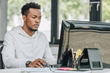 young african american programmer working on computer in office clipart