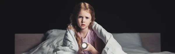 Panoramic Shot Scared Child Sitting Bedding Holding Flashlight Isolated Black — Stock Photo, Image