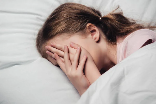 Scared Child Covering Face Hands While Lying White Bedding — Stock Photo, Image