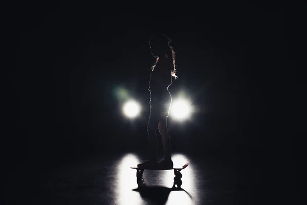 Child Riding Penny Board Darkness Illumination Headlights Black Background — Stock Photo, Image