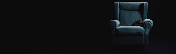 panoramic shot of grey armchair isolated on black with copy space