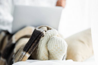 selective focus of woman in white socks with blanket  clipart