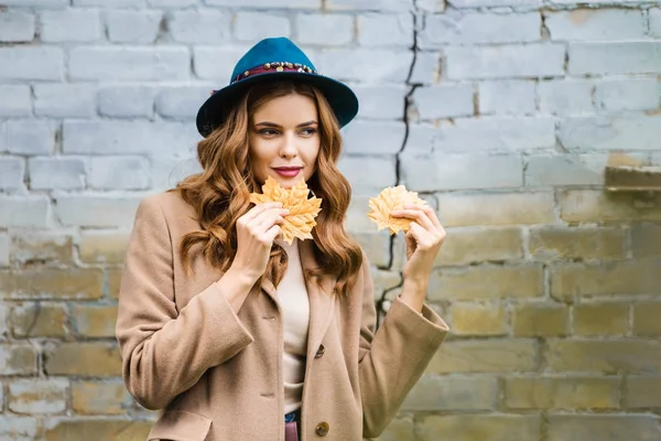 Attractive Woman Blue Hat Looking Away Holding Yellow Leaves — Stock Photo, Image