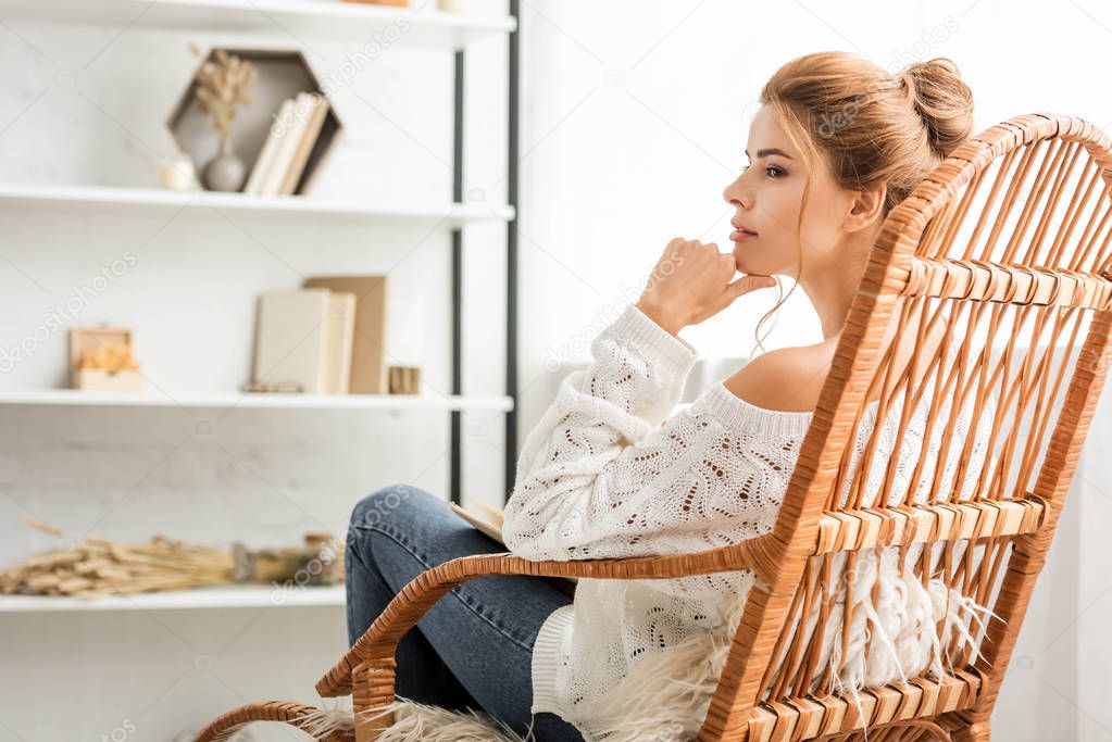 attractive woman in white sweater sitting on rocking chair
