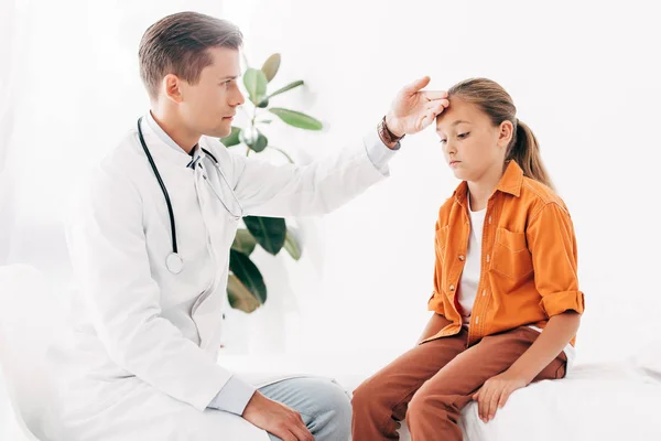 stock image pediatrist in white coat taking temperature of child