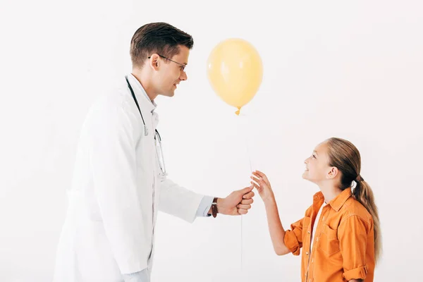 Pediatra Casaco Branco Dando Balão Amarelo Para Criança Isolada Branco — Fotografia de Stock