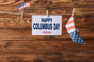 ahşap yüzeyüzerinde Amerikan ulusal bayrakları ve kağıt tekne arasında mutlu Columbus gün yazıt ile kart