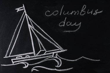 blackboard with ship drawing and Columbus Day inscription clipart