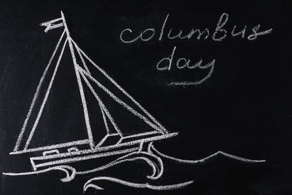 blackboard with ship drawing and Columbus Day inscription