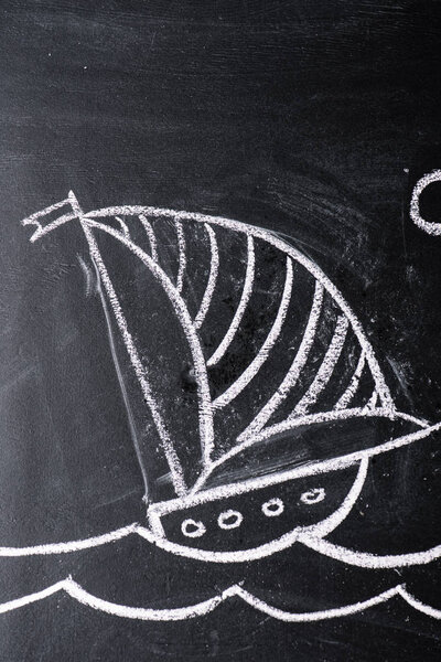 ship with striped sail drawing on chalkboard