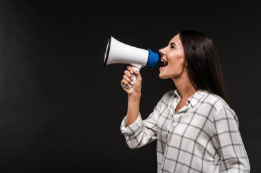 side view of cheerful woman screaming in megaphone isolated on black  clipart