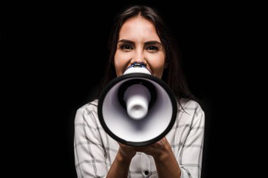 cheerful woman holding megaphone isolated on black  clipart